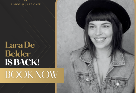 Promotional poster for Lincoln Jazz Café: grayscale photo of Lara De Belder in a denim jacket and black hat, with gold border and the text 'Lara De Belder IS BACK! BOOK NOW' and the café logo.